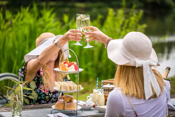 women in garden drinking champagne